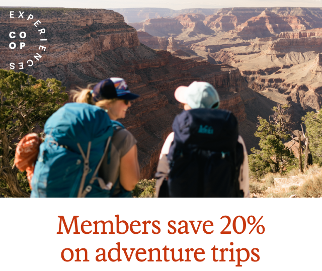 A couple hikers take in the view of the Grand Canyon. Headline: CO-OP EXPERIENCES. Members save 20% on selected adventure trips