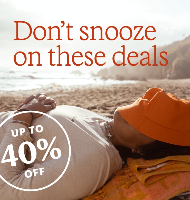 A person taking a siesta on the beach. Headline: Dont snooze on these deals